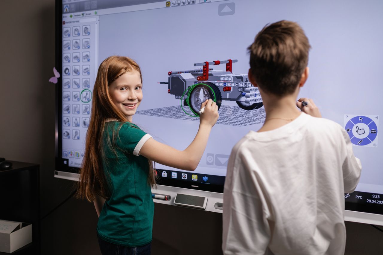 Children using a digital screen in a classroom
